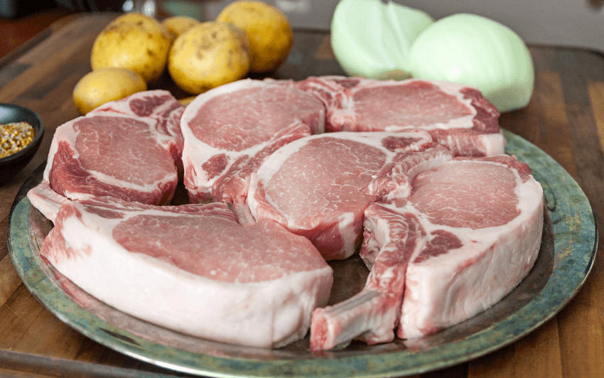 Apple smoked pork chops on a charcoal grill-1.png